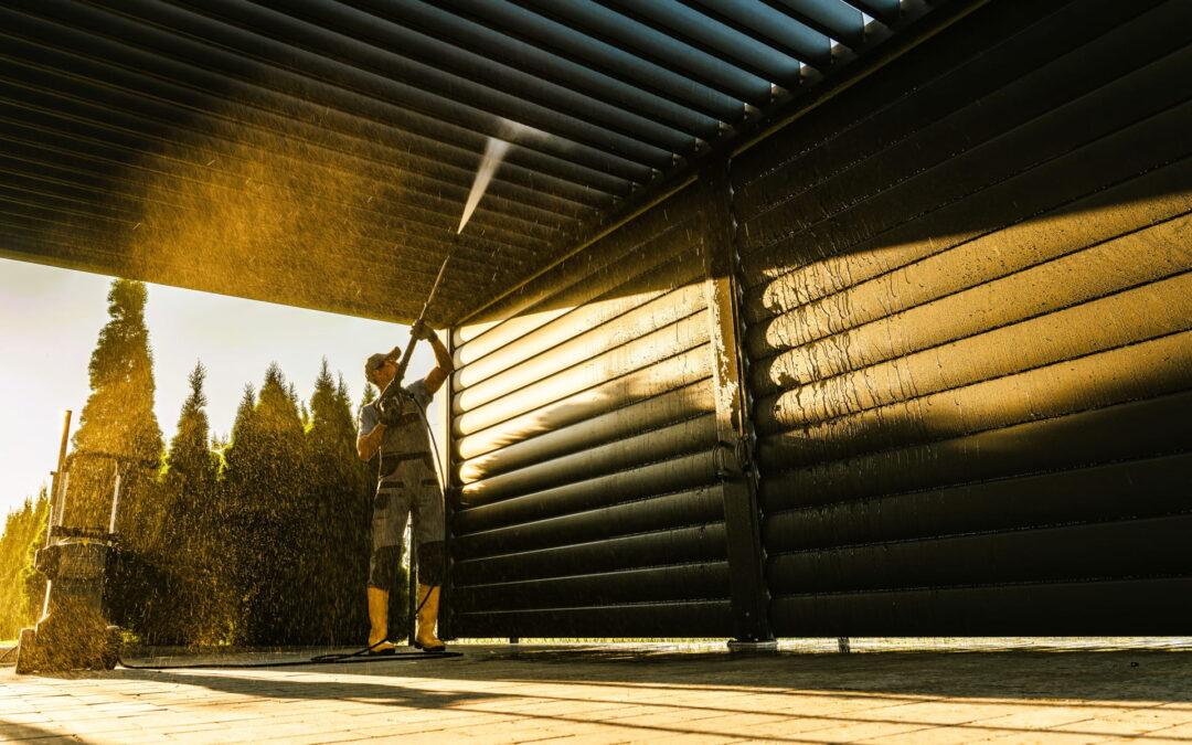 man-pressure-washing a building