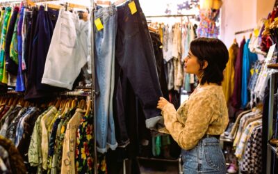 young woman looking for clothes on rack NTYCE Clothing Exchange Voted Best Thrift Store in Knoxville 2025