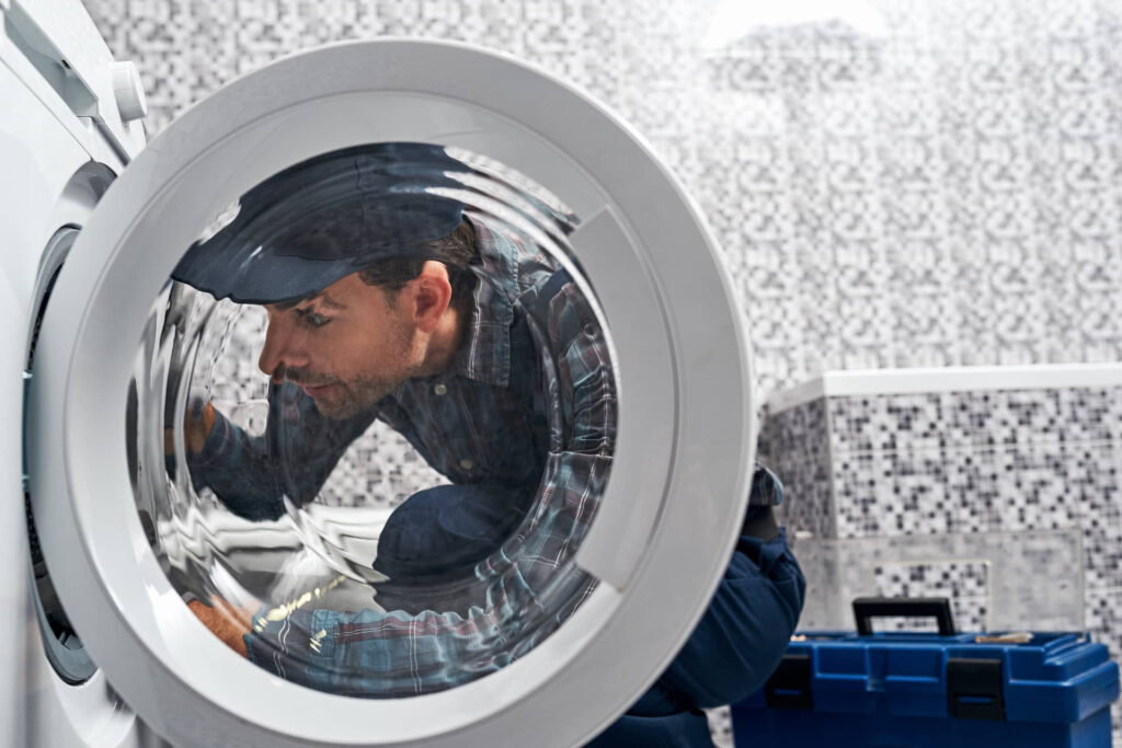 Repairman fixing a washing machine