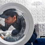 Repairman fixing a washing machine