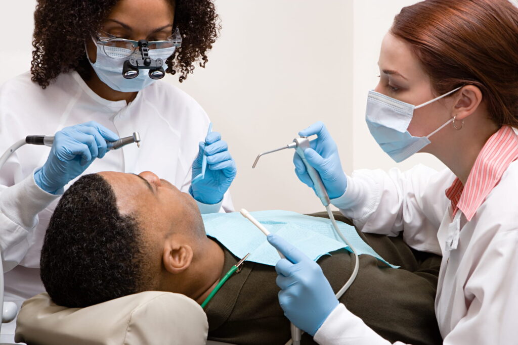 Seeing a Dentist in New Orleans Dentist and assistant with a patient