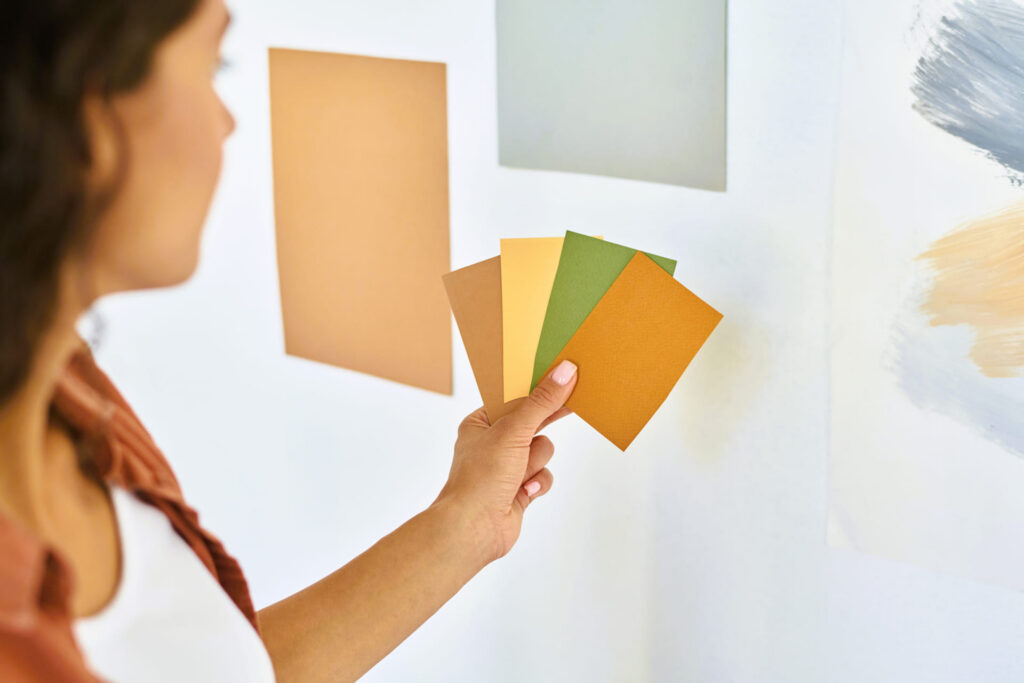 paint colors can differ Woman looking at paint swatches